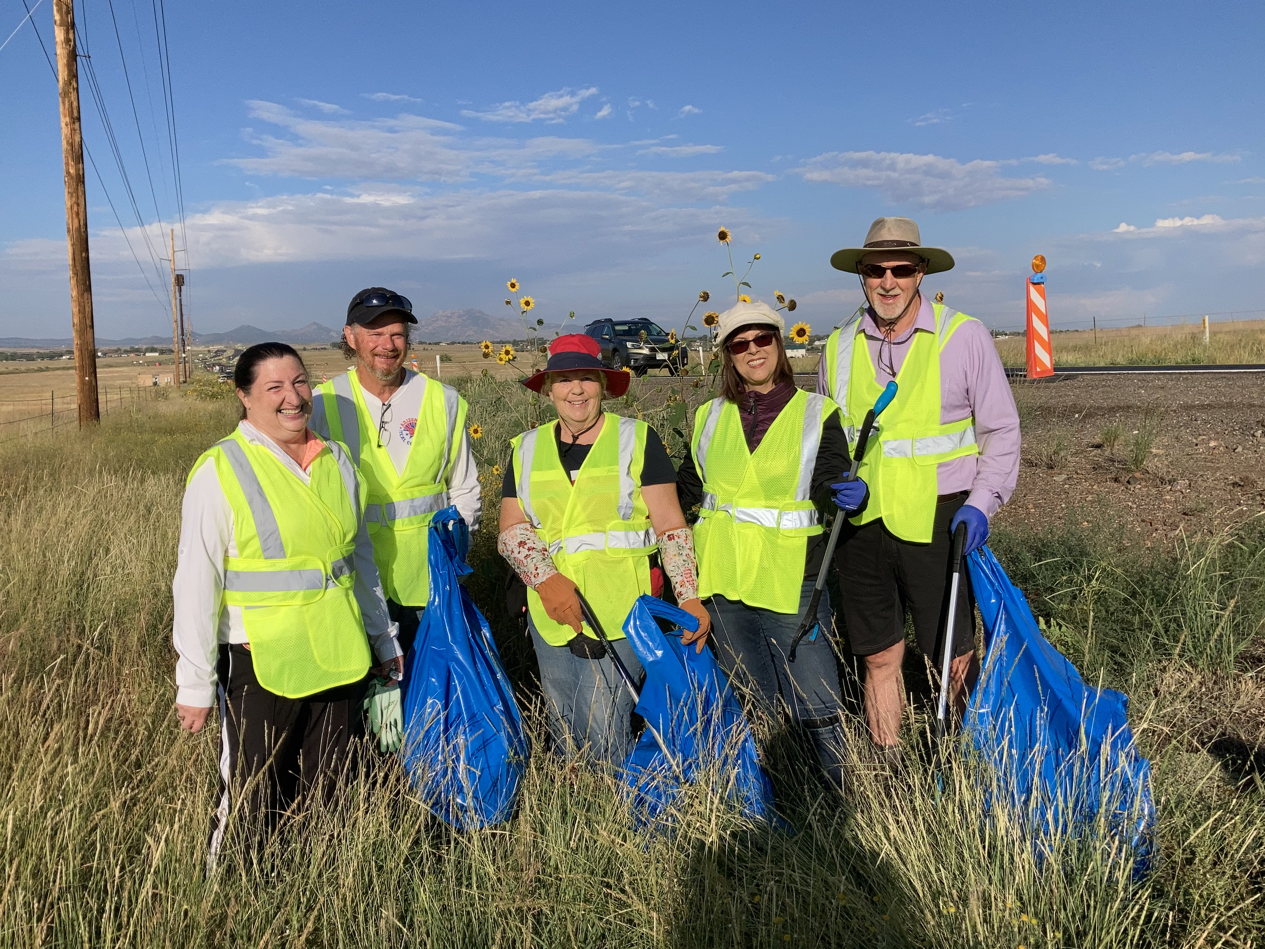 Adopt a Highway volunterrs pose along highway.