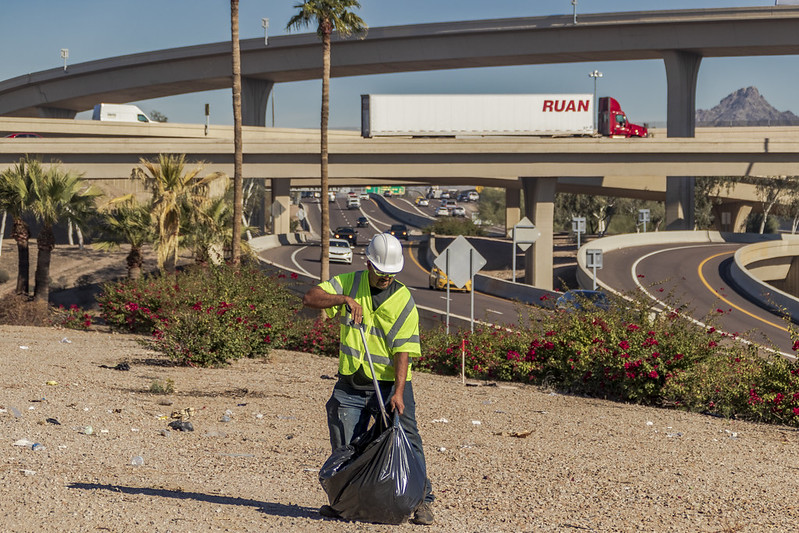 ADOT maintenance crew member collecting litter along Maricopa County freeways
