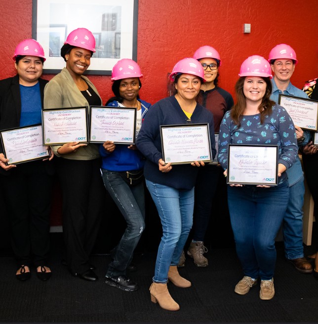 Construction academy graduates pose with certificates