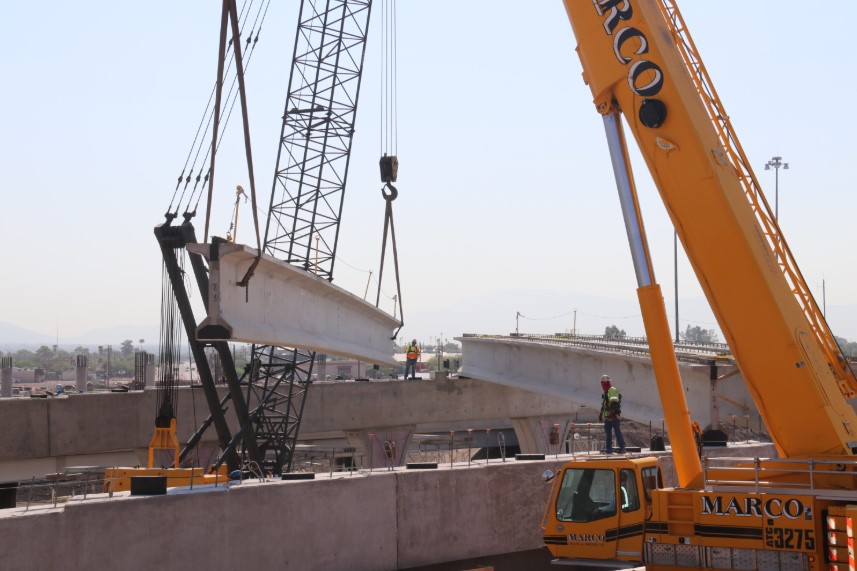 Crane lifts bridge girder