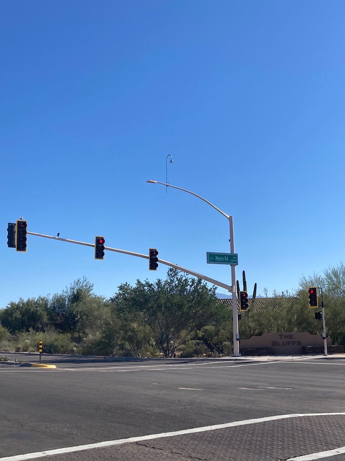 New traffic signal on Moore Road in Marana. Blue sky and desert vegetation on the intersection. New ADA ramps.