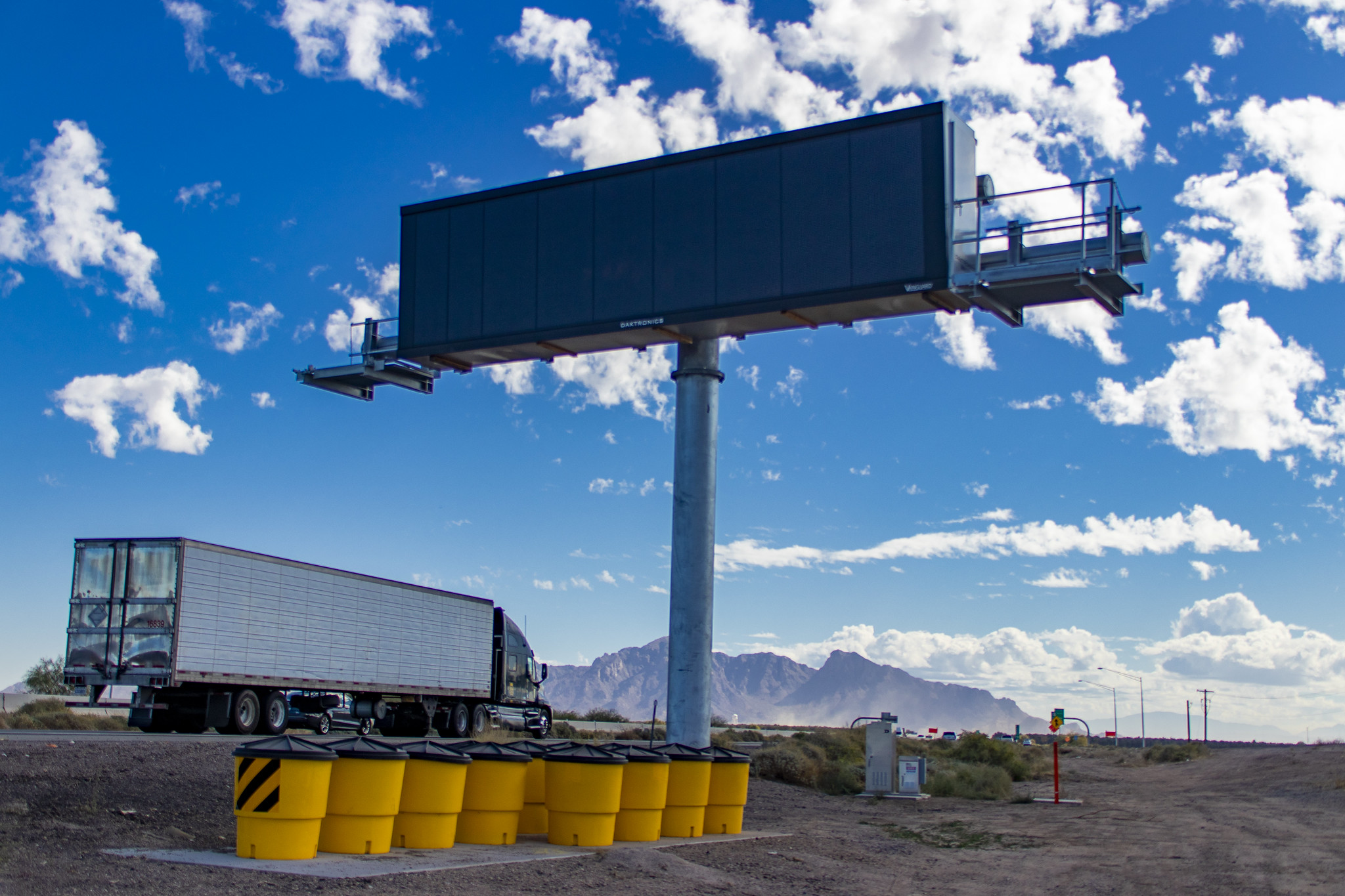Truck drives past message board in I-10 dust detection system