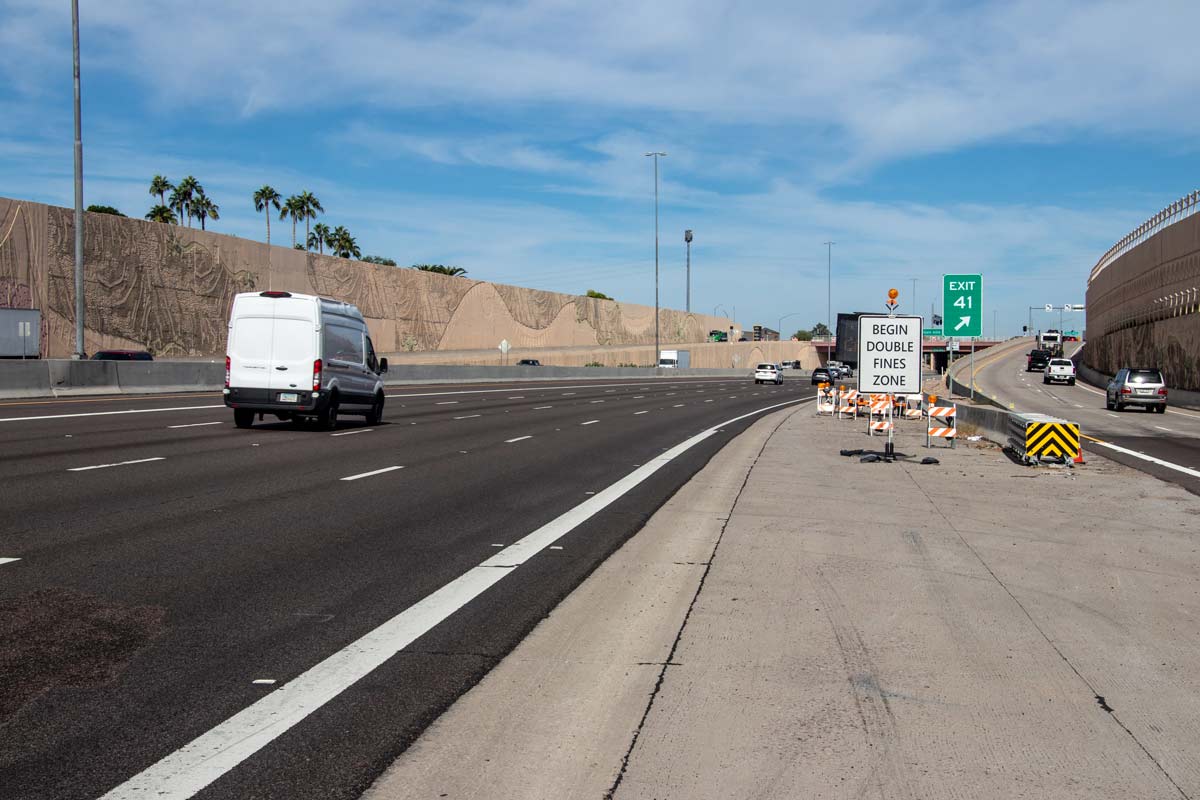Loop 101 highway segment near Exit 41 with ‘Begin Double Fines Zone’ sign and construction barriers present.