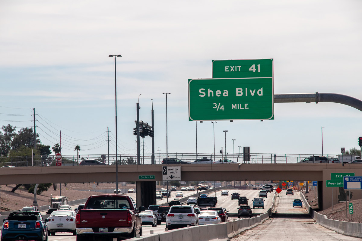 Loop 101 highway segment near Exit 41 with ‘Begin Double Fines Zone’ sign and construction barriers present.