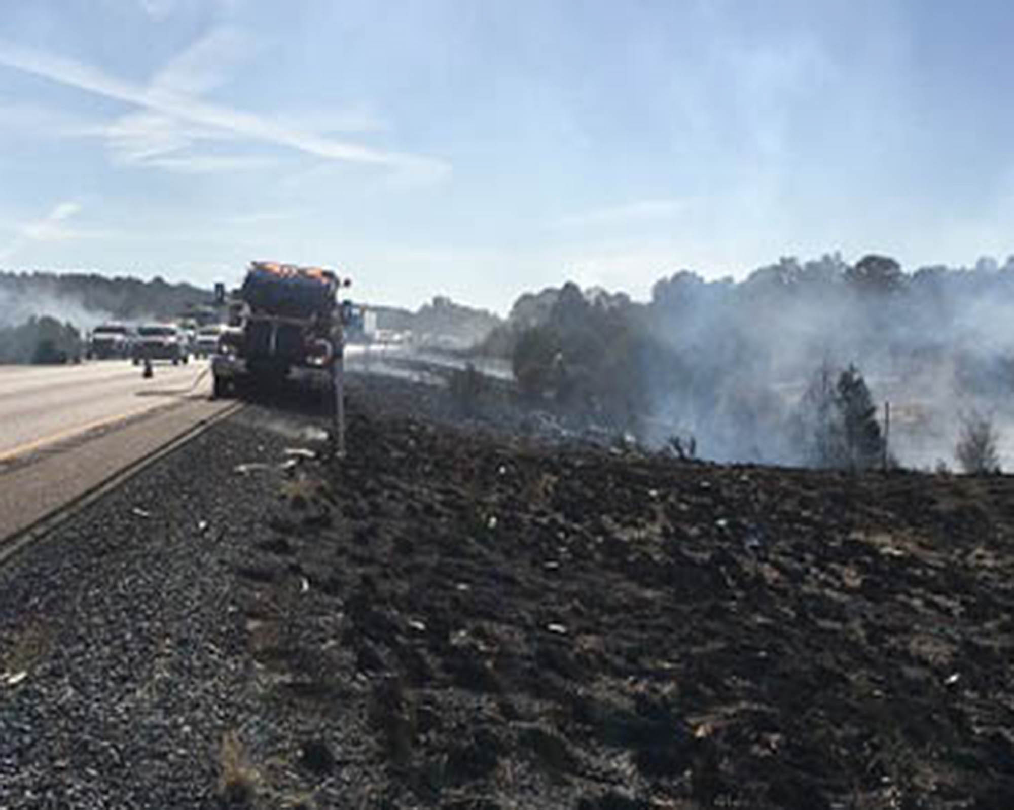 Still-smoldering fire along freeway