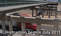 Partially constructed overpass above a highway with a red truck passing underneath; text reads Construction begins July 2011.