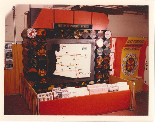 Exhibit display with a large map about the U.S. Interstate System, pamphlets, and a know the facts wheel.