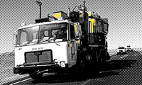 A large road maintenance vehicle travels on a highway; image is mostly black and white with yellow highlights.