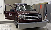 A maroon Ford SUV with equipment attached to the front is parked indoors with its driver door open. Text on the image reads Road Profiler: Calibration.