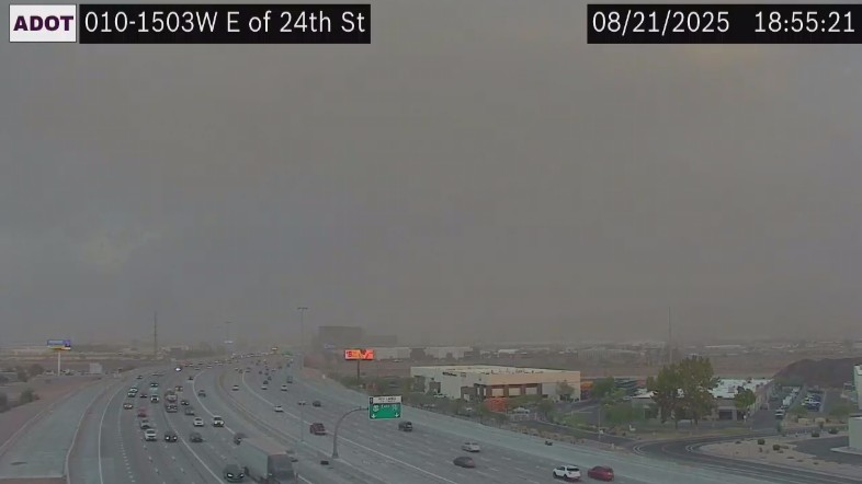 Traffic camera view of blowing dust on urban freeway
