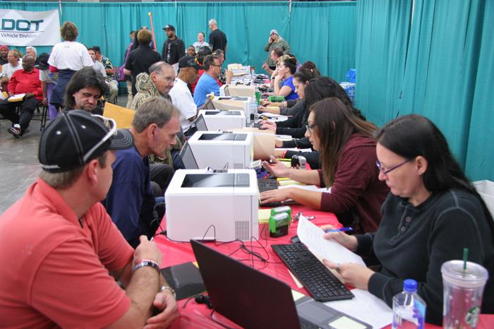 Motor Vehicle Division workers at table helping veterans