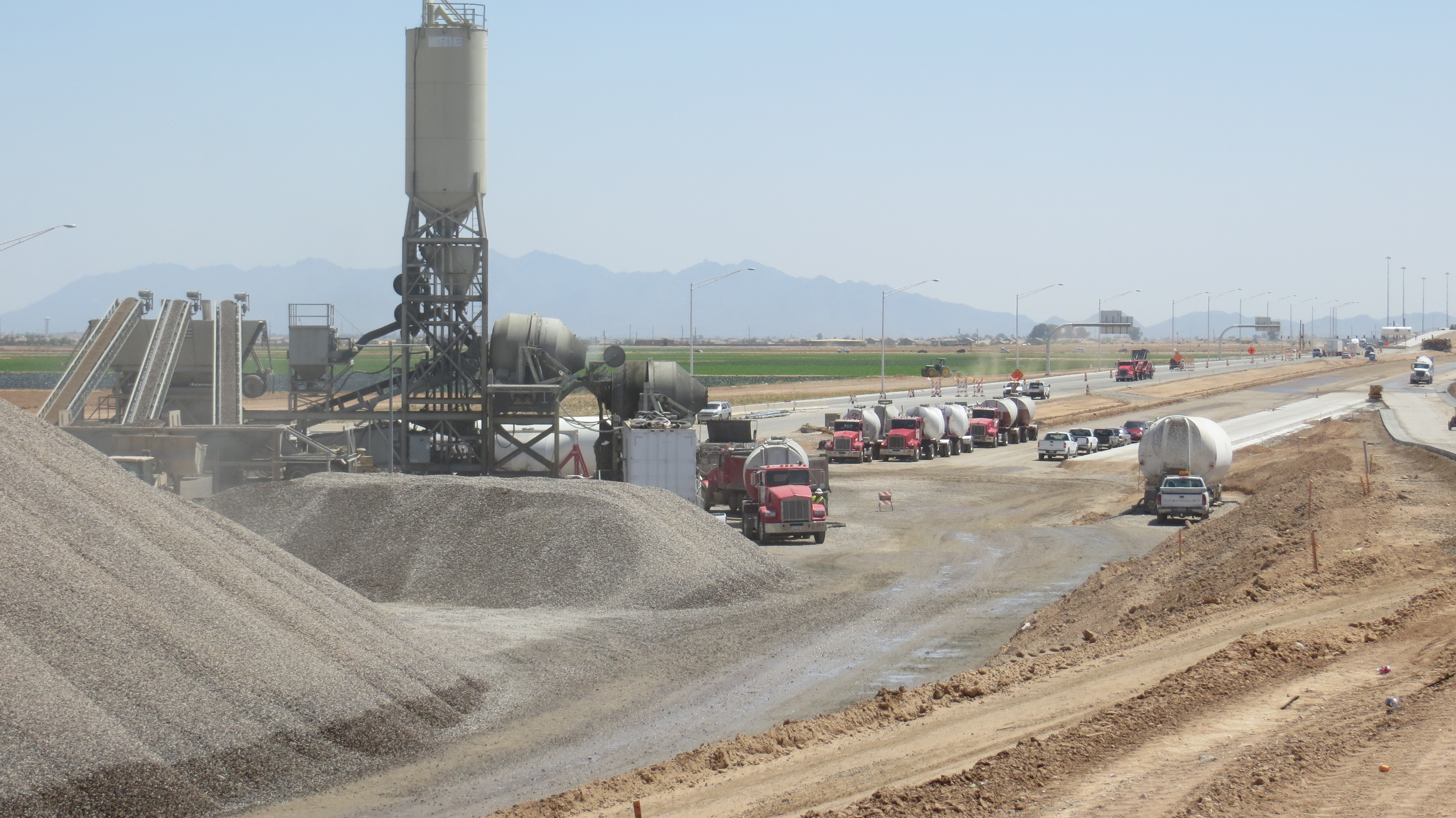 Line of cement trucks entering batch plant