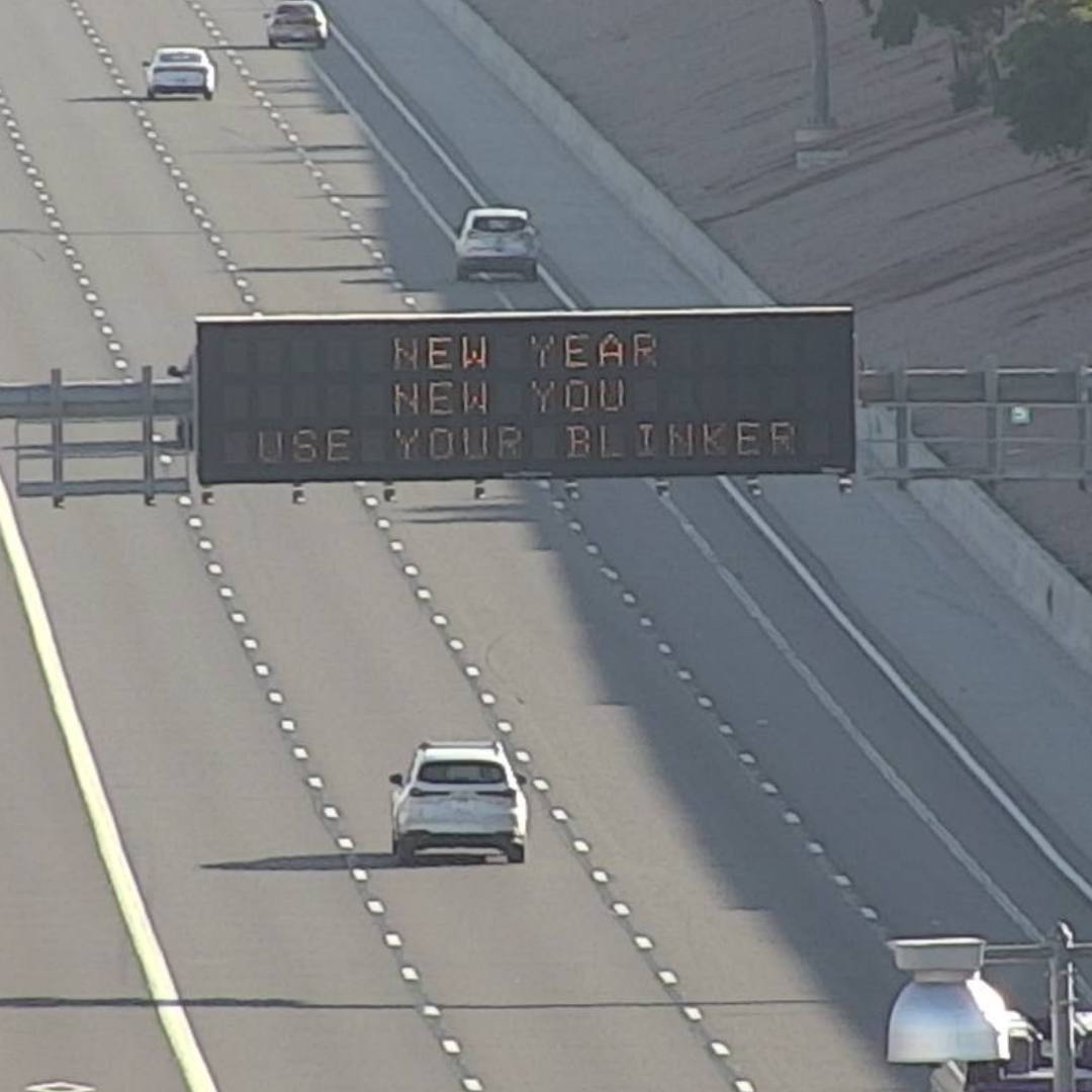 A digital message board on the highway encourages motorists to use their blinker.