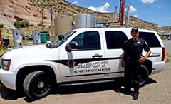 ECD officer in front of ADOT enforcement vehicle