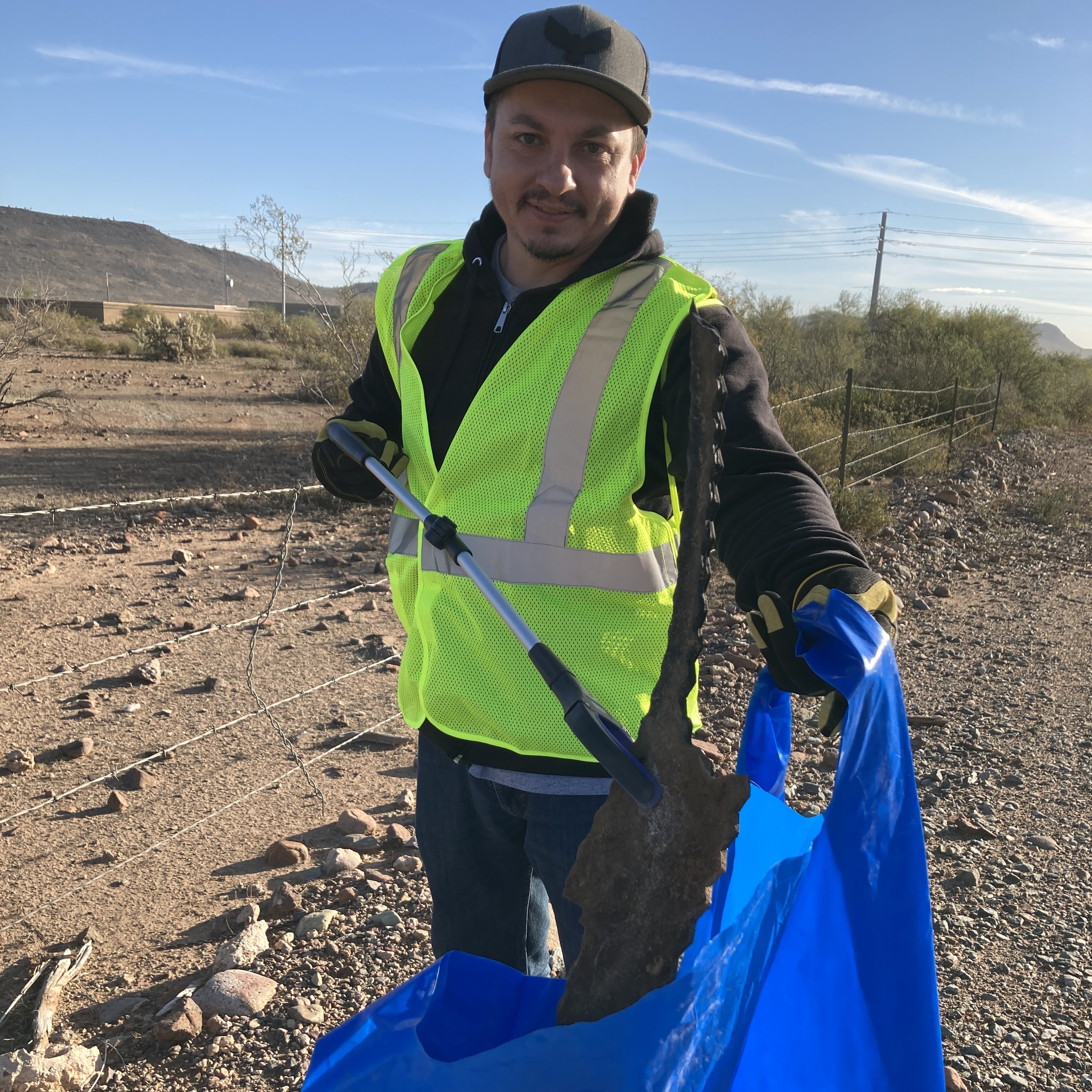 Volunteer picking up trash on SR 74