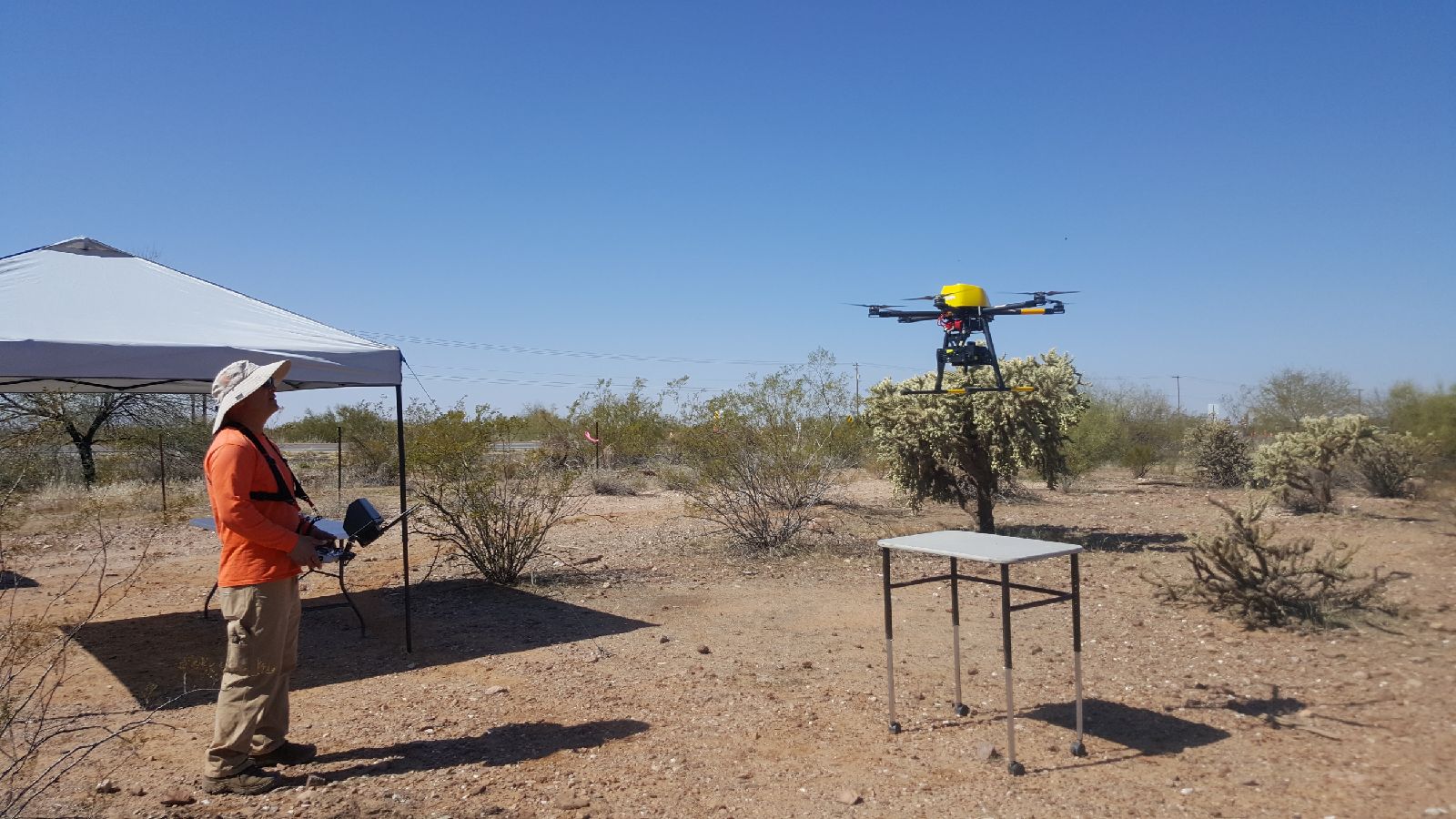 Man flying a drone in the desert
