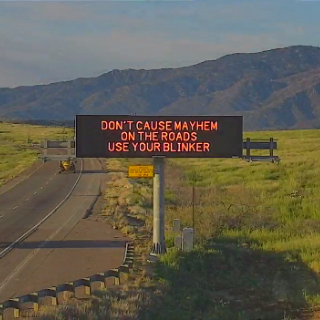 A digital message board on the highway encourages motorists to drive with care.