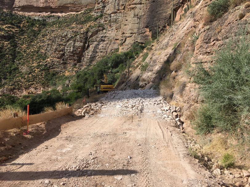 Rockfall debris covering a narrow canyon roadway during SR 88 cleanup operations.