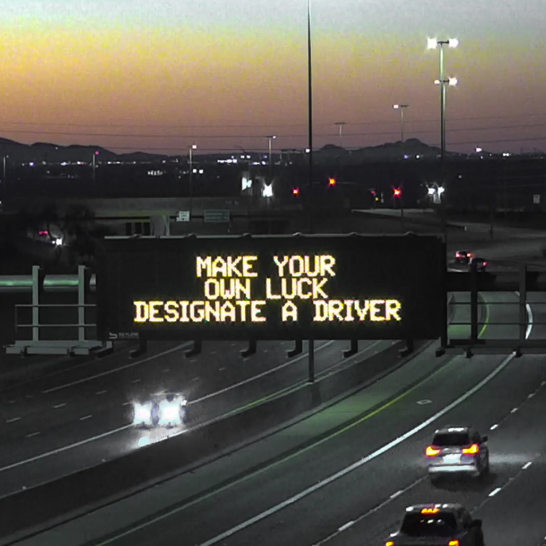 A digital message board on the highway encourages motorists to designate a driver.