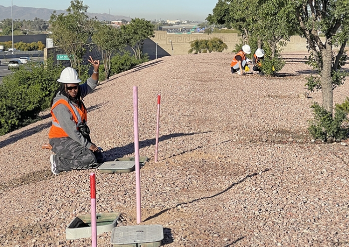 ASU student checks irrigation along highway.