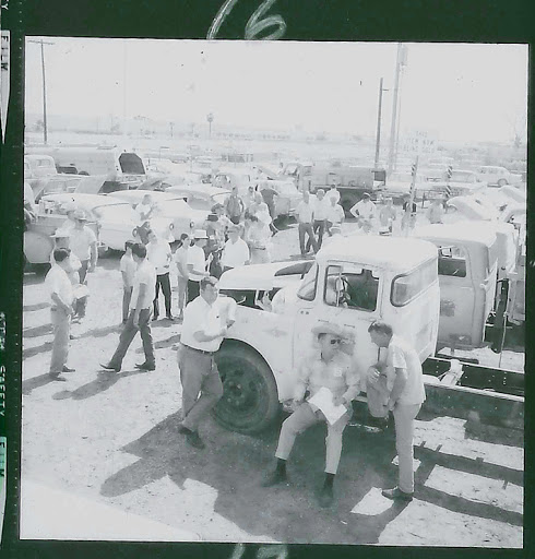 Old auction with trucks and people