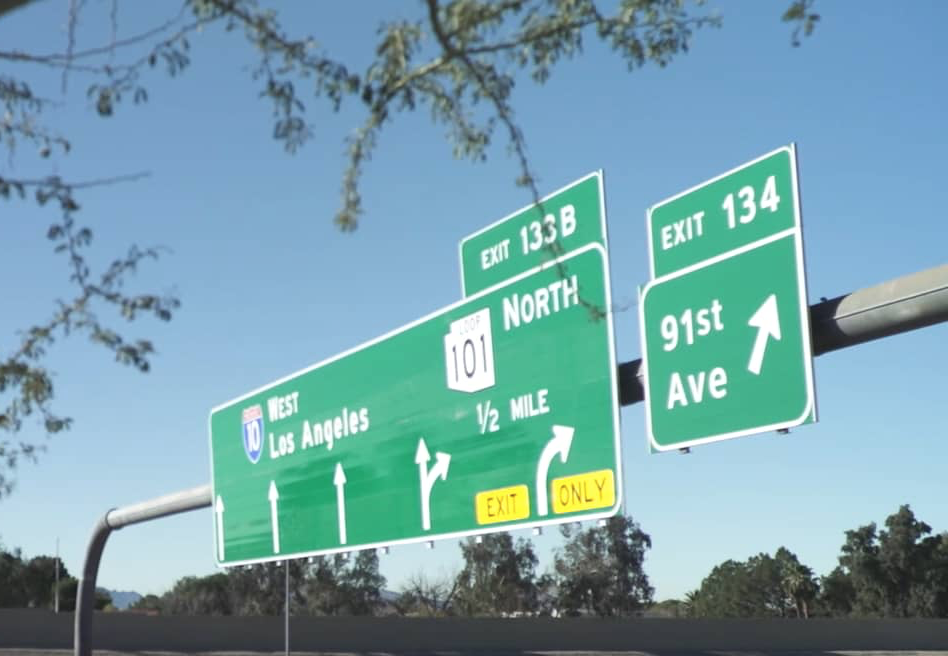 Overhead freeway sign showing I-10 west and 101 north