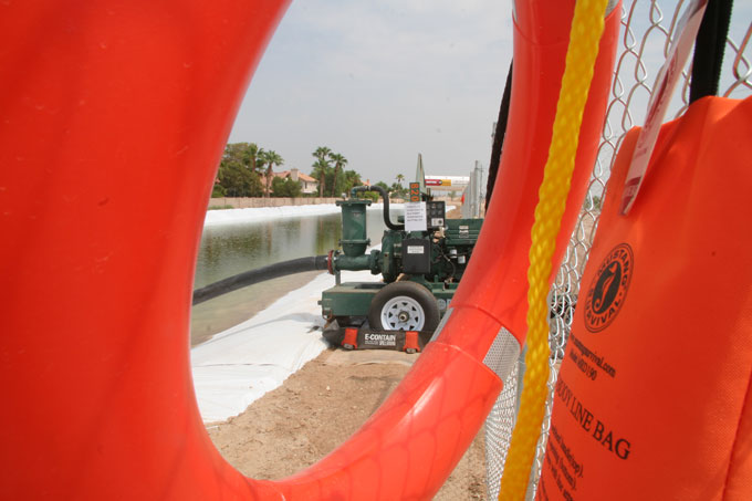 Construction pond seen through life preserver ring