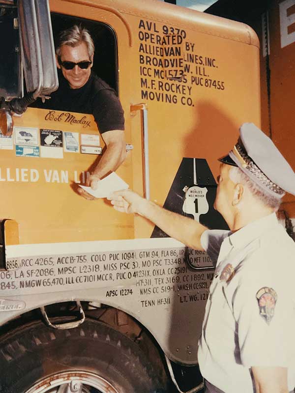 Truck at port of entry with driver and officer
