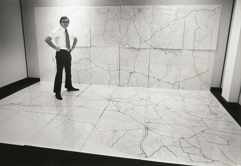 Man standing on map on wall and floor