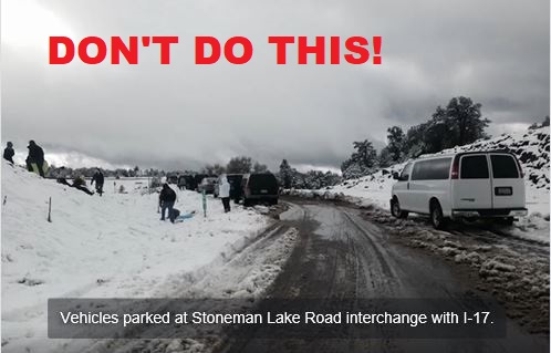 Vehicles stopped to play in snow alongside I17