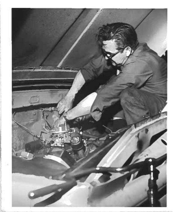 Man working on vehicle engine