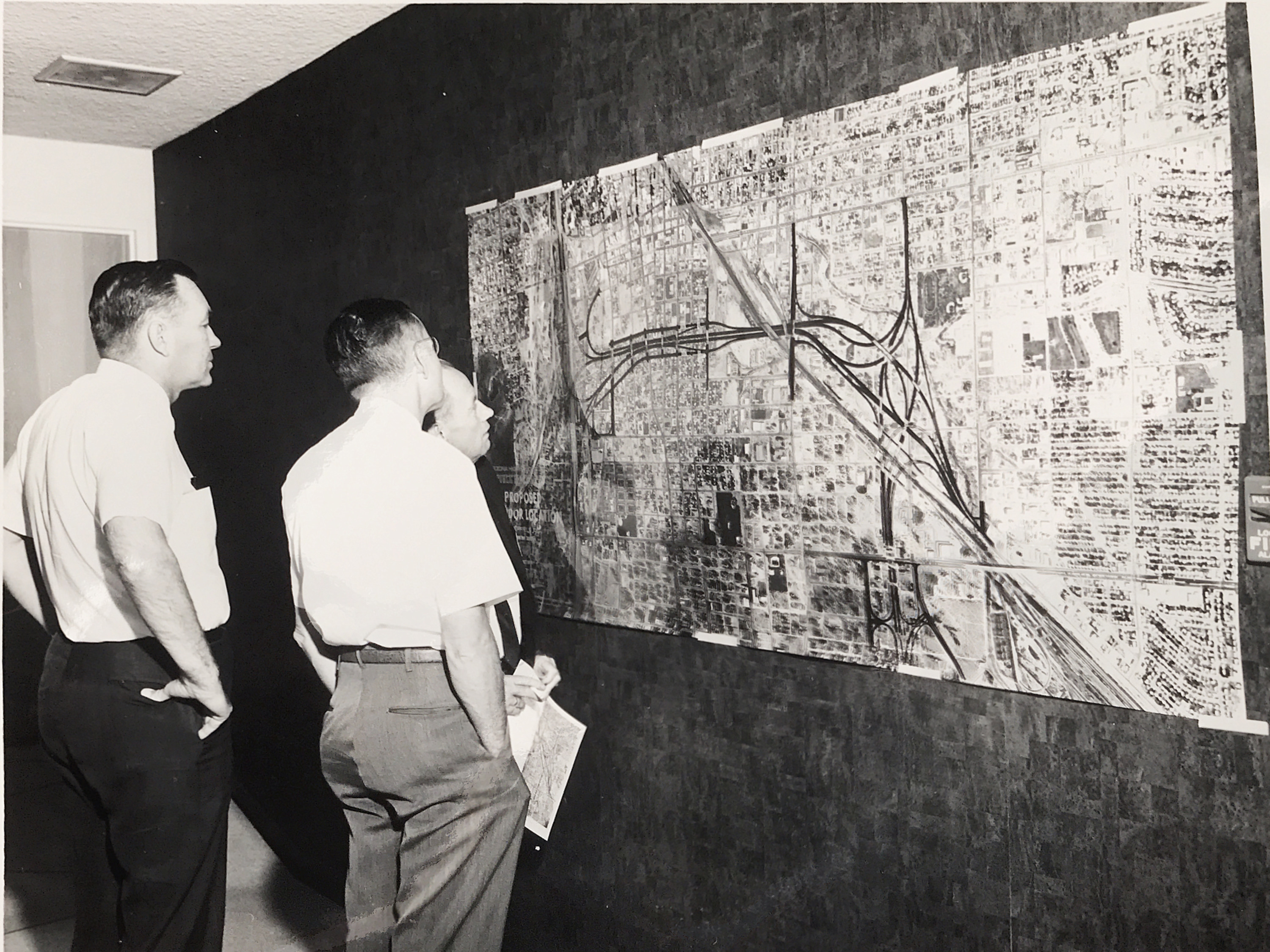 People looking at road map on the wall
