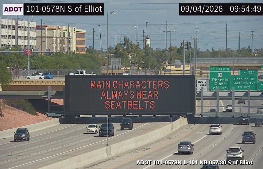 A digital highway sign that encourages drivers to wear seat belts.