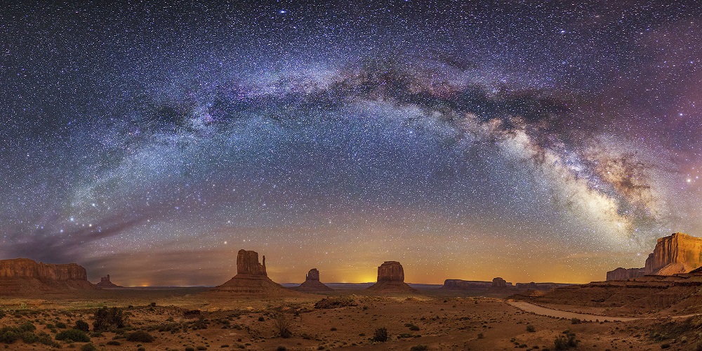 Photo of Milky Way arching over Monument Valley