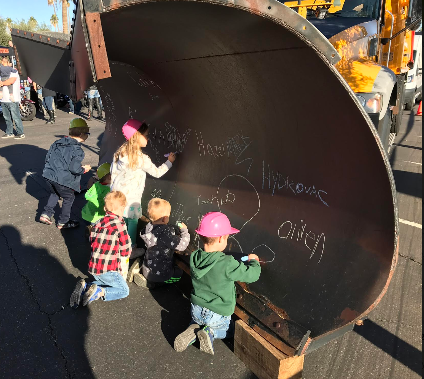 Kids sign names during Touch a Truck
