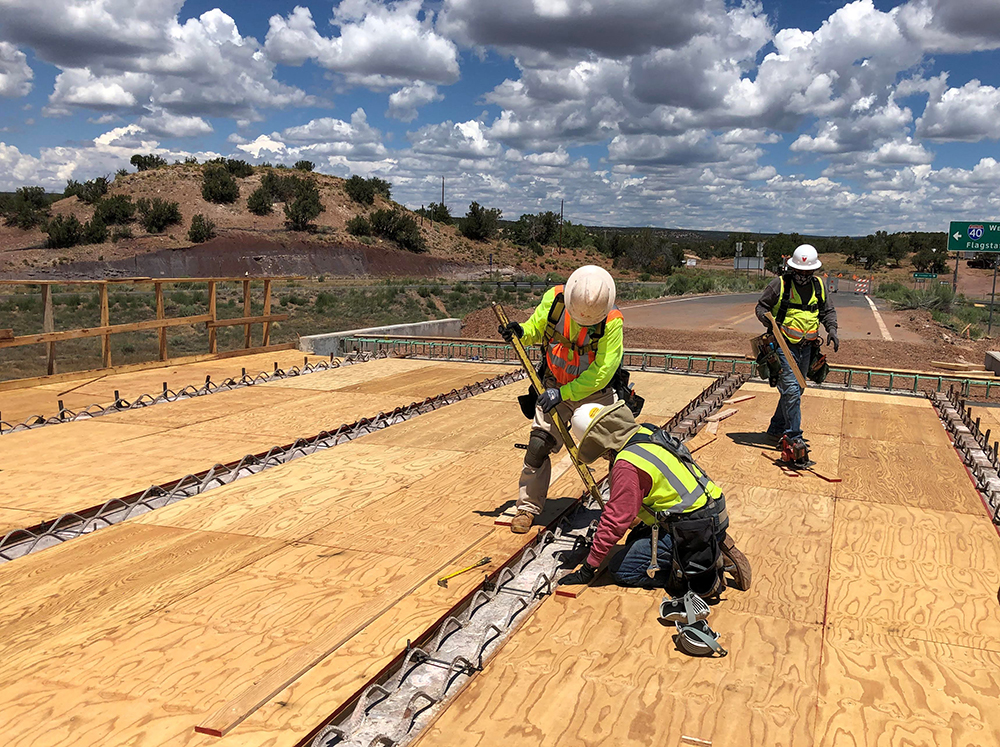 Workers constructing new bridge deck on the St. Anselm bridge