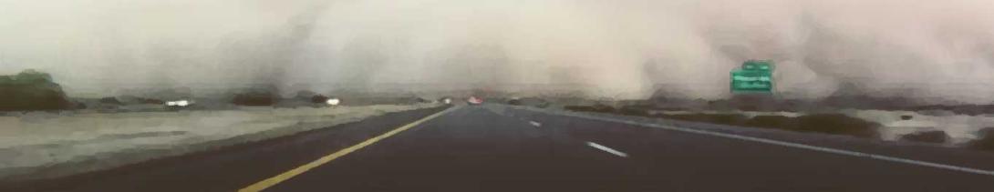 approaching dust storm on highway