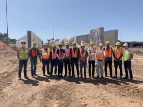 Thirteen people standing in construction safety gear