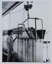 A man puts a sign in a machine.