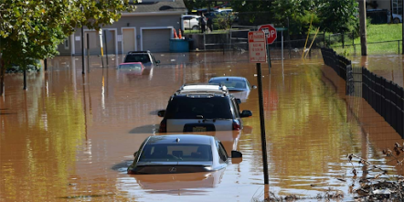A flooded street with submerged cars.