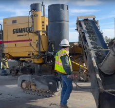 Crews preparing for using the slipforming method to build a concrete barrier