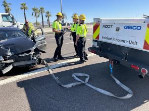 Workers at the scene of a car crash on the highway