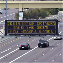 A digital message board on the highway encourages motorists to designate a driver.
