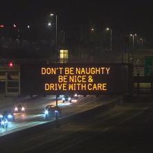 A digital message board on the highway encourages motorists to drive with care.