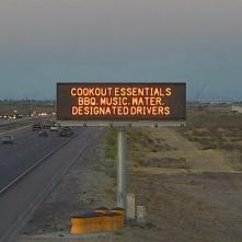 A digital message board on the highway encourages motorists to designate a driver.