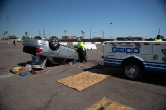 An ADOT truck pulling an overturned vehicle in a parking lot.