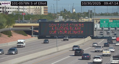 A digital message board on the highway encouraging drivers to use their blinker.