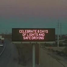 A digital message board on the highway encourages motorists to drive safe.