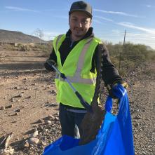 Volunteer picking up trash on SR 74