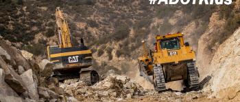 Adot kids image road construction heavy equipment moving bouders.